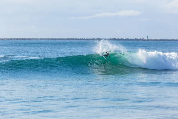 Surfer surfing action of hollow tube ride blue summer ocean waves landscape