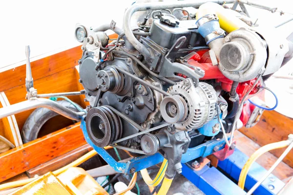 Boat engines that show belts, motors, wires and pipes