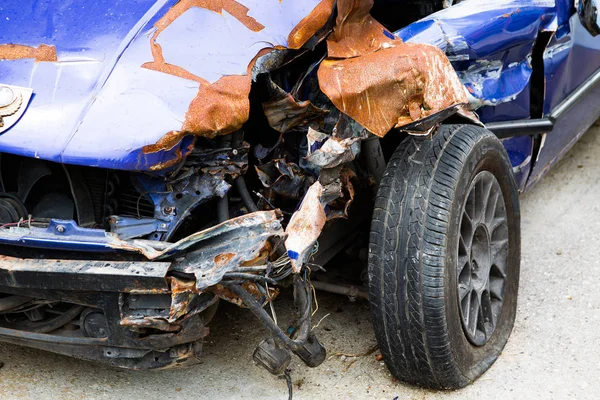 The blue car that had been in the front accident until unable to drive.