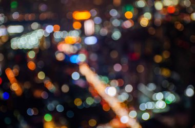 Odaklanmamış kentsel doku Bokeh şehir ışıkları ve arka plandaki trafik sıkışıklıkları bulanık ışıklar, gece hayatı.