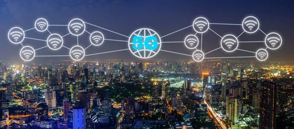 Communication network concept 5G and internet of things with smart city on night background. Modern city with wireless network connection concept, 5G network interface and wifi icon concept