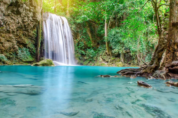 Deep forest waterfall at Erawan waterfall, beautiful waterfall with sunlight rays in deep forest, Erawan National Park in Kanchanaburi, Thailand