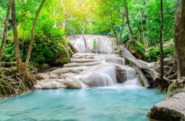Erawan şelalesinde derin orman şelalesi, ormanın derinliklerinde güneş ışınları olan güzel şelale, Tayland, Kanchanaburi 'deki Erawan Ulusal Parkı.