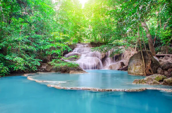 Deep forest waterfall at Erawan waterfall, beautiful waterfall with sunlight rays in deep forest, Erawan National Park in Kanchanaburi, Thailand