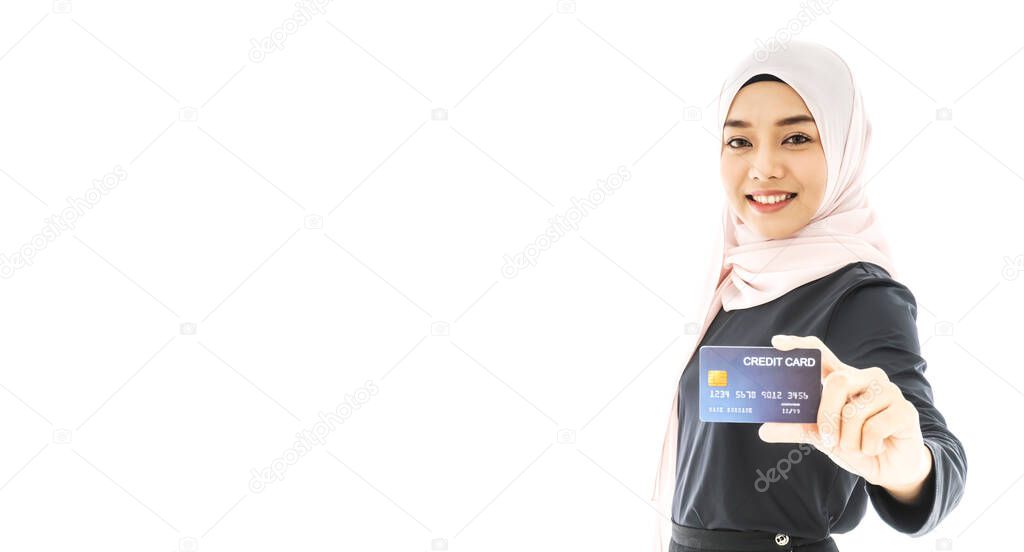 Portrait of beautiful asian muslim woman in a black hijab holding credit card with happy and smiling isolate on white background. Business and finance credit card concept. 