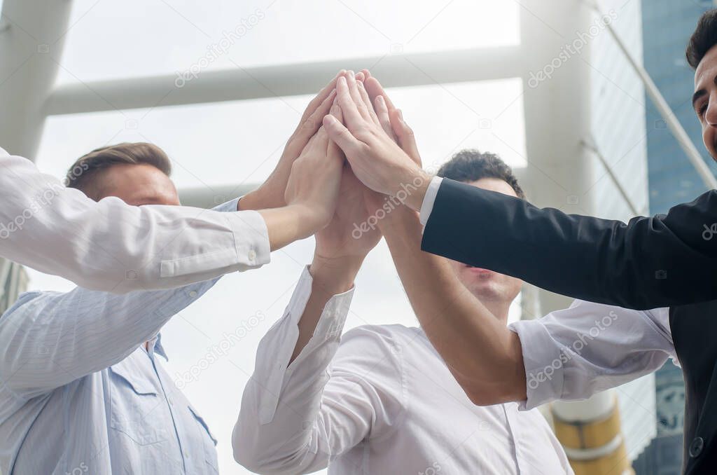 Close up image of Business success Team which hand of the work force combine power tag team or Group of diversity people hand assemble high five for good teamwork, Successful project is done.
