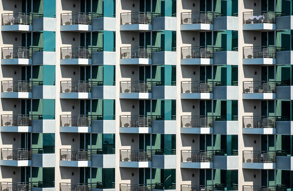 Pattern of hotel room balconies in modern building. Art
