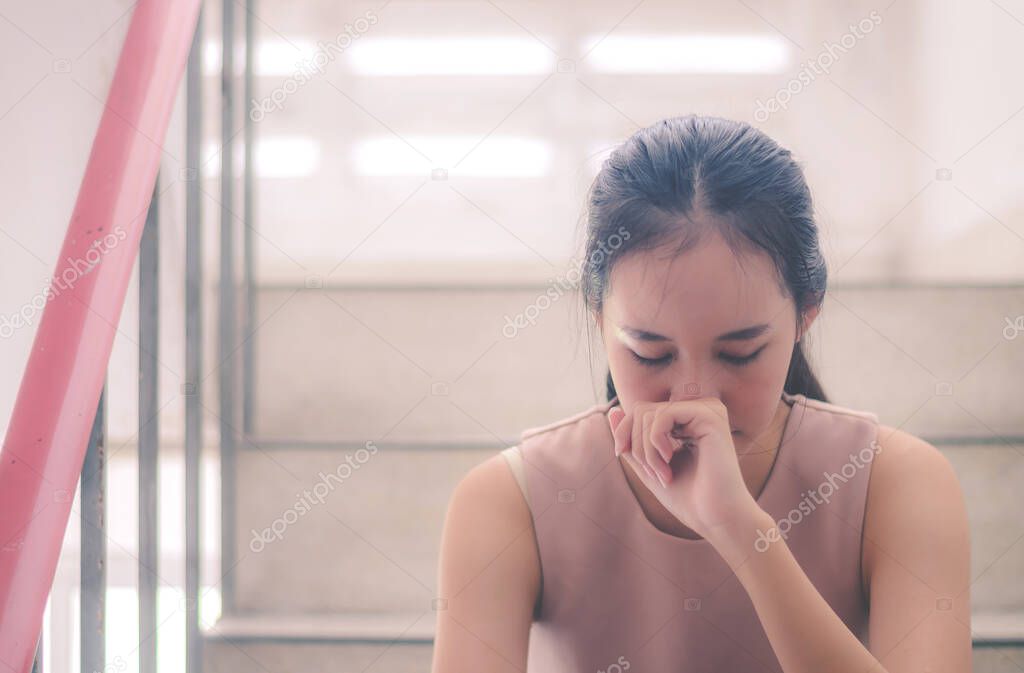 Unhappy depressed teenager with face in hands sitting stair at old condo , Sad girl, Cry, drama concept