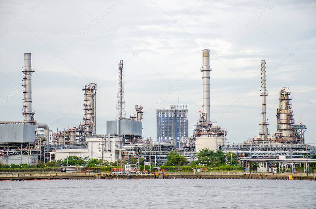 Oil refinery plant of Petrochemistry industry in sunset time, gas and oil production processing in Bangkok, Thailand.