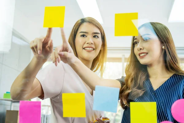 Two Young Business Woman Pointing Sticky Note Papers Glass Thinking — Stock Photo, Image