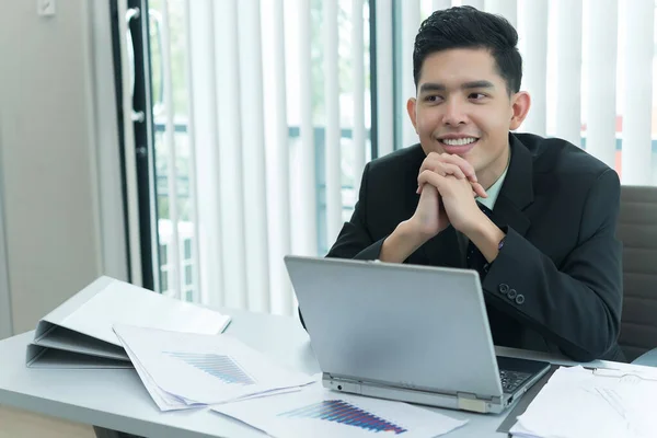 Young asian employee working at laptop during working day in office