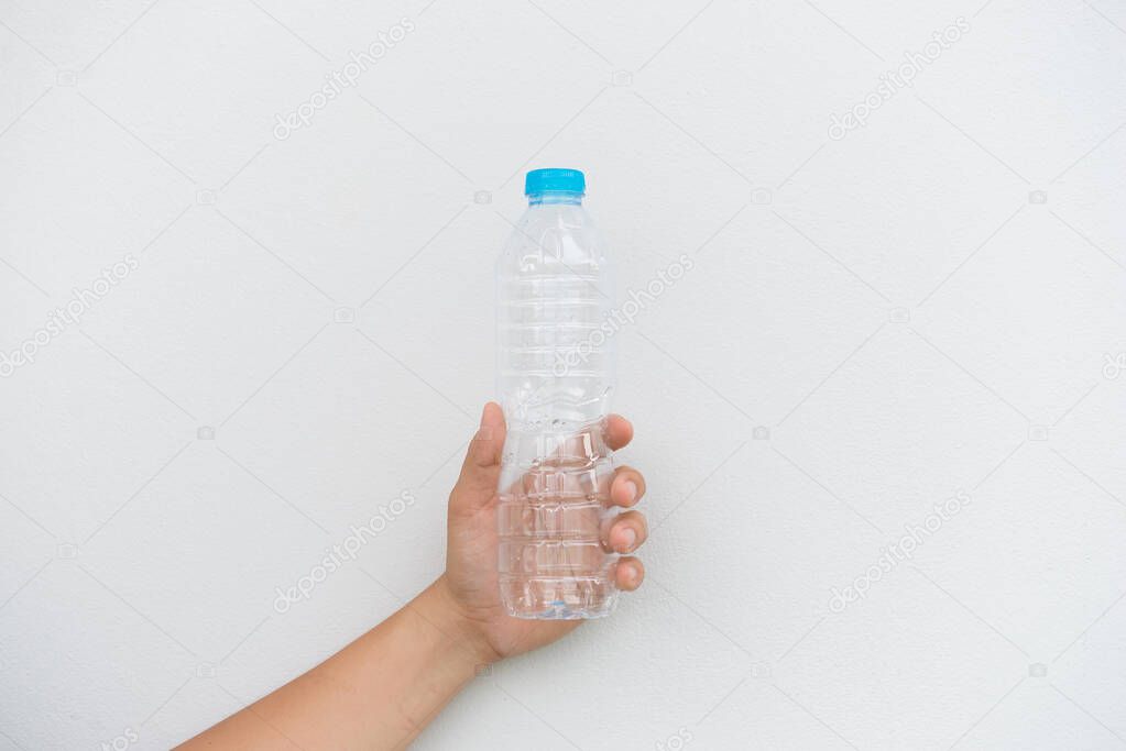 Empty bottle of water in hand on white background