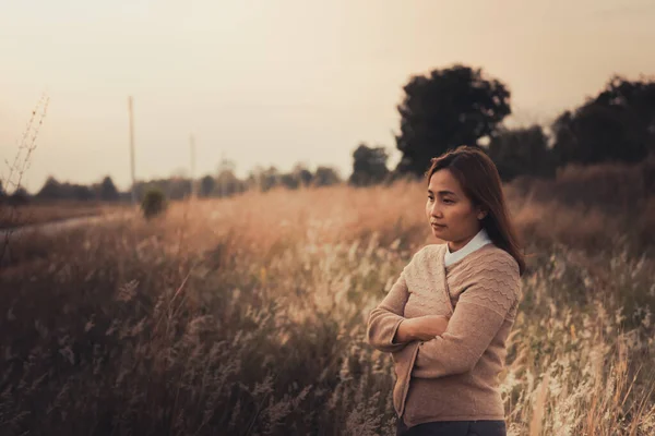 Portrait of lonely woman alone in a field. Vintage filter style.she heartbreak from love,sad girl concept on sunset vintage style