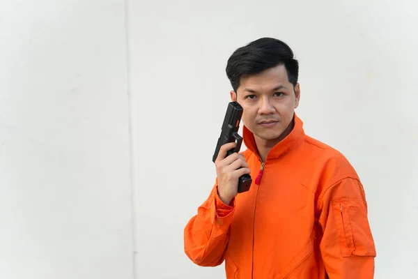 Bandit with gun in hand on white background,Thailand people,Prisoner concept