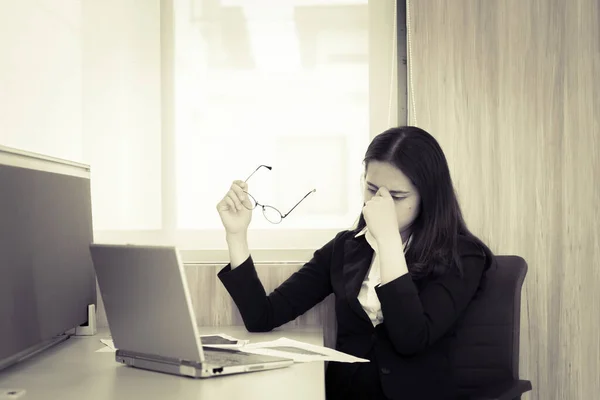 Asian businesswoman stress from hard work,Thai worker woman working in the office,Dark tone