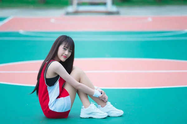Beautiful asian woman posing on basketball field, Thailand people
