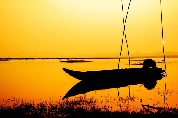 empty boat silhouette during sunset