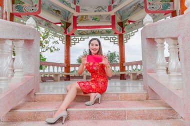 Mutlu Çin yeni yılı. Geleneksel Cheongsam giysileri giyen Asyalı bir kadın.