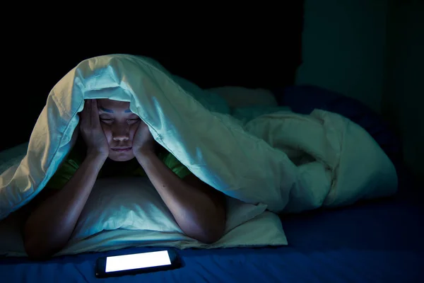 Asian woman play smartphone in the bed at night,Thailand people,Addict social media,Play internet all night