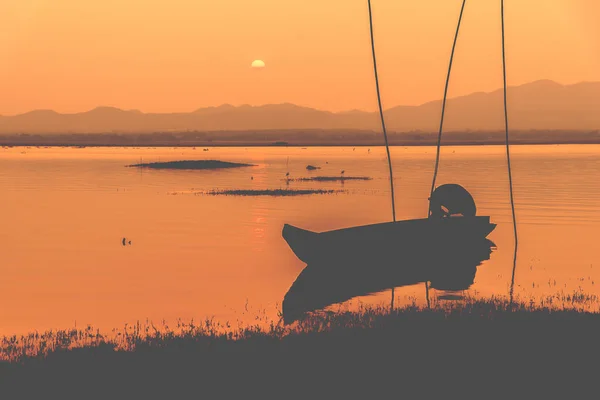 empty boat silhouette during sunset