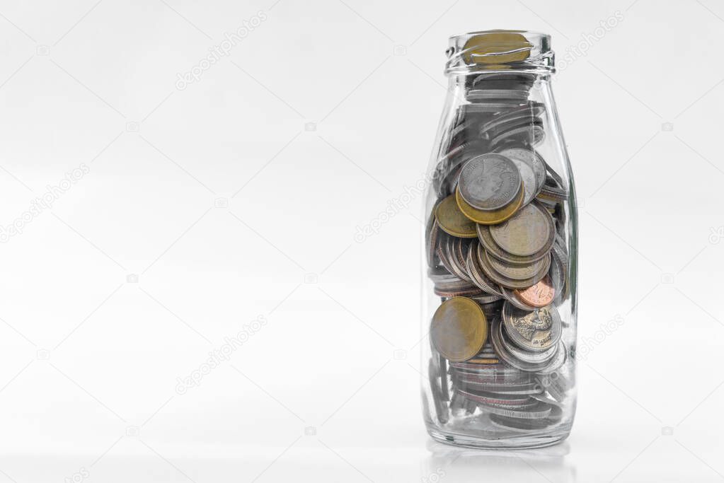 Many  gold coins in Bottle on white background