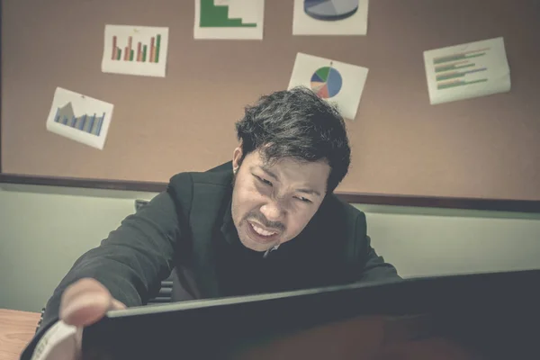 Asian businessman under stress during excessive work