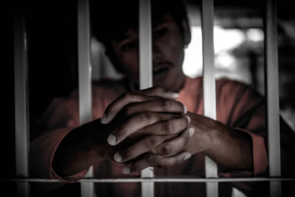 鉄の刑務所をつかもうとするアジア系男性囚人の概念タイ人自由への希望 — ストック写真