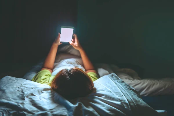 Asian woman play smartphone in the bed at night,Thailand people,Addict social media,Play internet all night