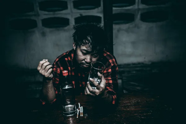 Asian man drink vodka alone at home on night time,Thailand people,Stress man drunk concept