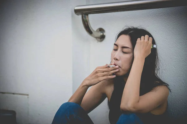 Asian woman sad from love,She smoking because stress from boyfriend,Heartbreak woman concept