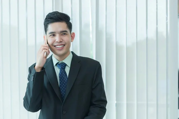 Asian businessman talk telephone with customer,Thailand people happy