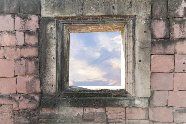 Stone window of ancient stone castle and visible sky