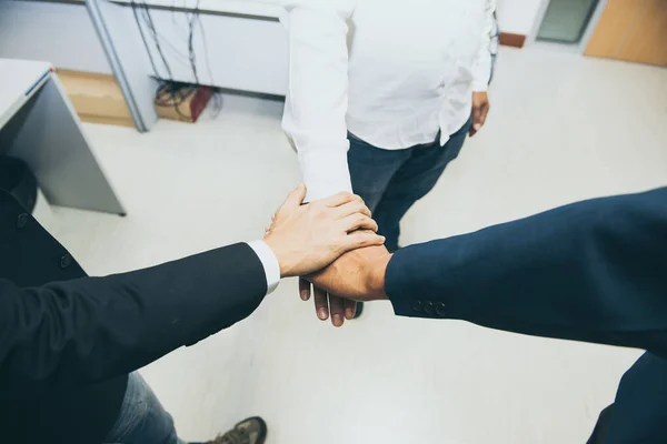 Three business people touch hand,teamwork  concept