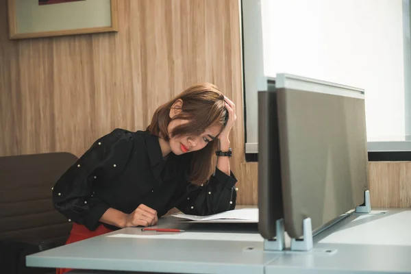 Asian woman working with the stress in the office.