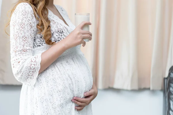 Pregnant woman with milk in her hand,Drinking milk is good health to the pregnancy