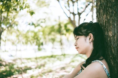 Asyalı, üzgün, güzel bir kadın. Gereksiz aşktan. Sevgilisi hakkında çok şey düşünüyor.