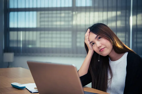 Asian businesswoman stress from hard work,Thai worker woman working in the office,Woman thinking concept