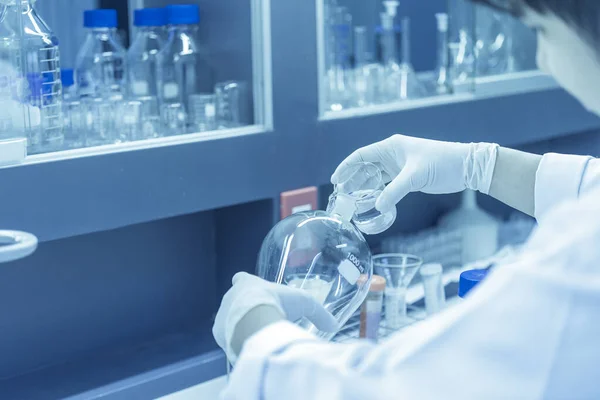 Scientist mix chemicals with The shake machine Before the experiment.Mixture laced with samples into test tubes,Thailand scientist working in the lab