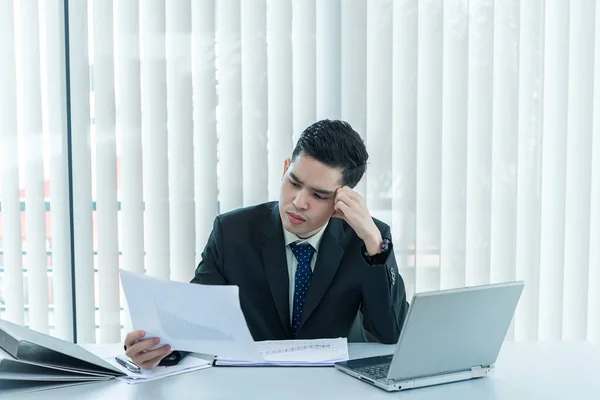 Young asian employee working at laptop during working day in office