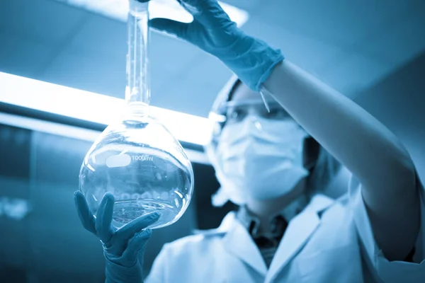 Asian Scientists holding big tube of experiment,Prepare experiment in lab,Thailand Scientist working in the laboratory