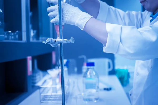 Scientist mix chemicals with The shake machine Before the experiment.Mixture laced with samples into test tubes,Thailand scientist working in the lab