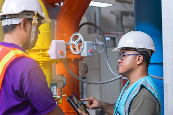 Two Asian Engineer Working Boiler Room Maintenance Checking Technical Data — стоковое фото