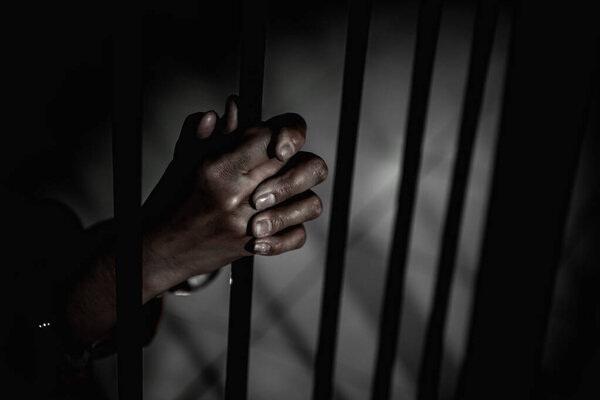 Hands of woman desperate to catch the iron prison,prisoner concept,thailand people,Hope to be free.
