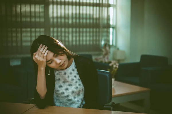 Asian businesswoman stress from hard work,Thai worker woman working in the office,Dark tone