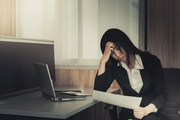 Asian businesswoman stress from hard work,Thai worker woman working in the office,Dark tone