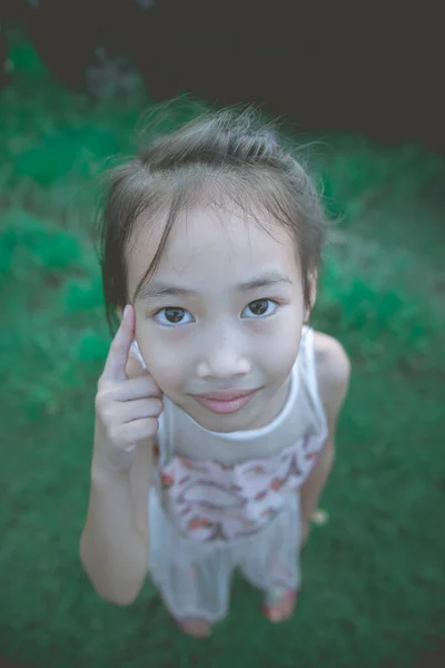 Little girl make mouth wow she use hand touch face vintage style,dark tone,cute,film,pastel,low key