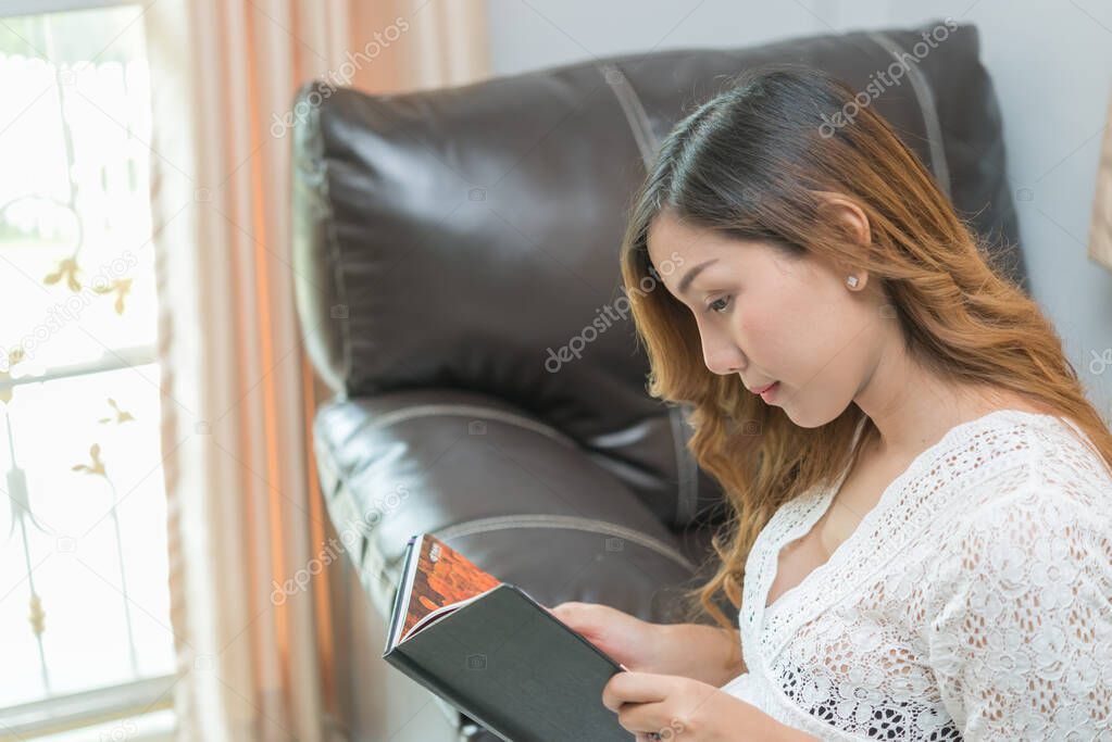 Asian pregnant woman read a book at home,Study of how to raise children,Thailand people