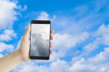 Cep telefonu ekranındaki karanlık gökyüzü açık mavi arkaplanda