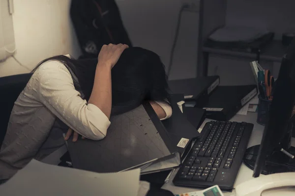 young business woman stressed from work overload while working in office