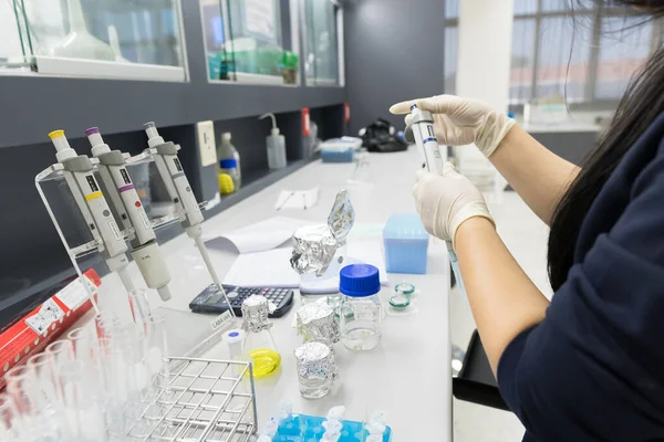 Asian scientist working in the lab,Experiment for customer,Using the formula, the physics and chemistry to calculate the value of the experiment,Thailand people